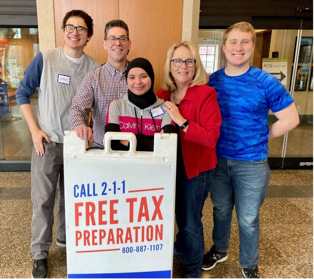 Accounting Professors Jonathan Brignall and Anne Sergeant with a Family participating in the VITA